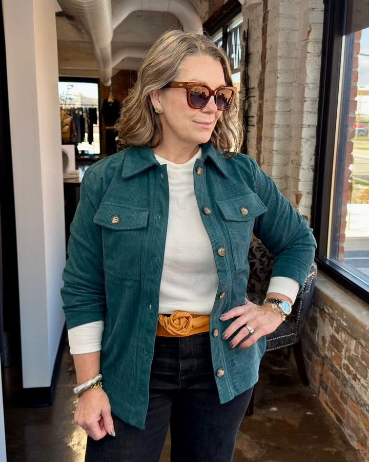 Corduroy Button Front Shacket in Jade Teal, spread collar with dual chest pockets and silver buttons styled over a white turtleneck, front view on model
