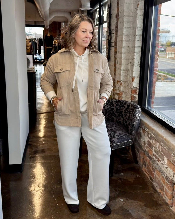 Corduroy Button Front Shacket in Beige styled with a cream hoodie and wide-leg ivory trousers, full outfit view on model
