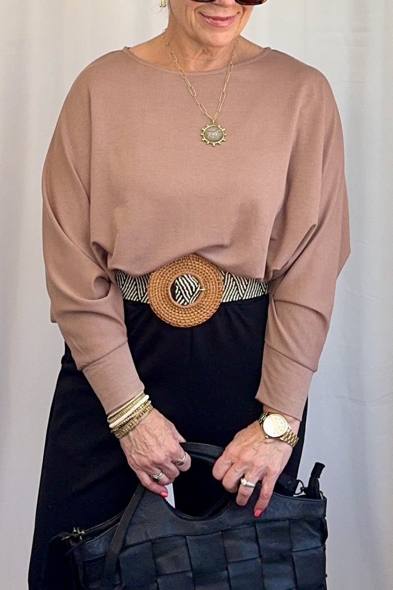 Cuffed Dolman Split Hem Relaxed Top in Taupe by Carole Christian — side full body view tucked and belted with wide-leg trousers and woven tote bag