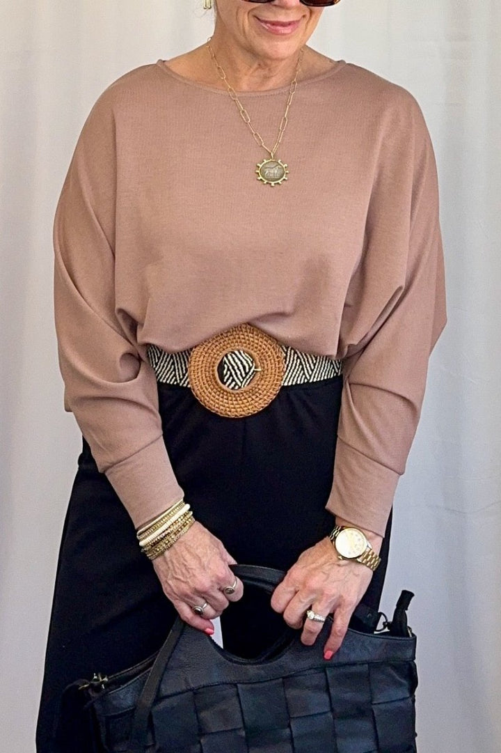 Cuffed Dolman Split Hem Relaxed Top in Taupe by Carole Christian — side full body view tucked and belted with wide-leg trousers and woven tote bag