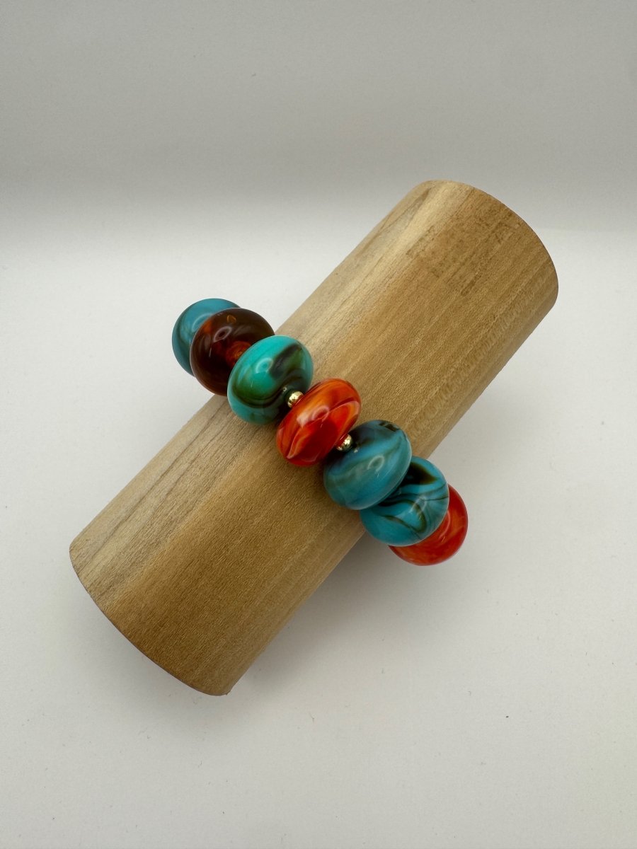 Current Mood Chunky Bracelet in Sunset — angled view on wooden display showing chunky resin beads
