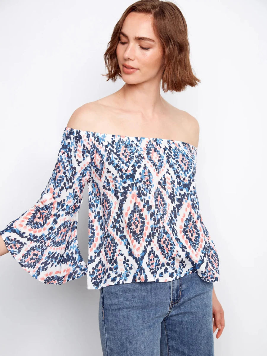 Charlie B Ikat Print Off-Shoulder Bell Sleeve Blouse in Nomad — close-up front detail on model