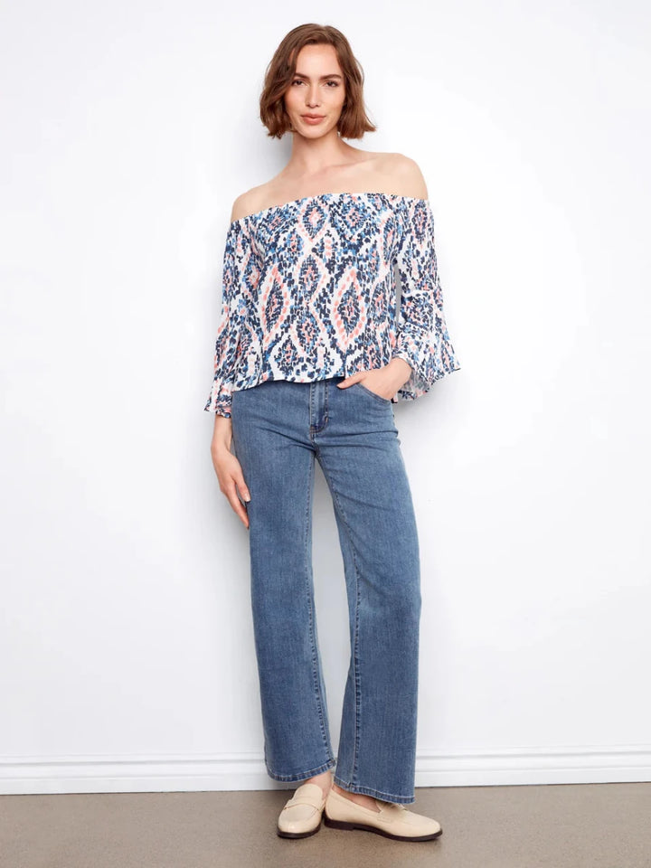 Charlie B Ikat Print Off-Shoulder Bell Sleeve Blouse in Nomad — full outfit view on model with wide-leg jeans