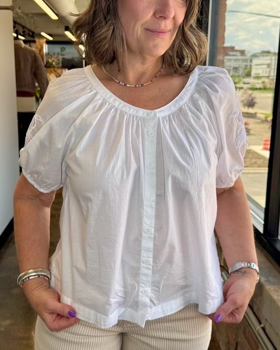 Dear John Denim Emiline Puff Sleeve Embroidered Top in White, gathered neckline and puff sleeves styled with tan corduroy, three-quarter view on model