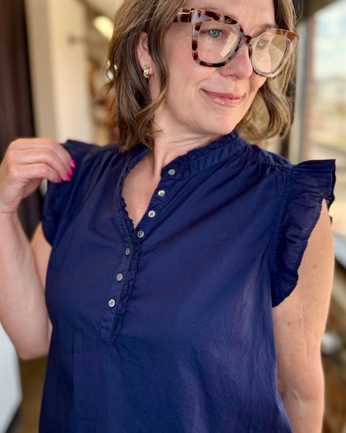 Close-up of Dear John Chatra Ruffle Sleeve Top in Black Iris, ruffled band collar with button placket and flutter sleeve detail

