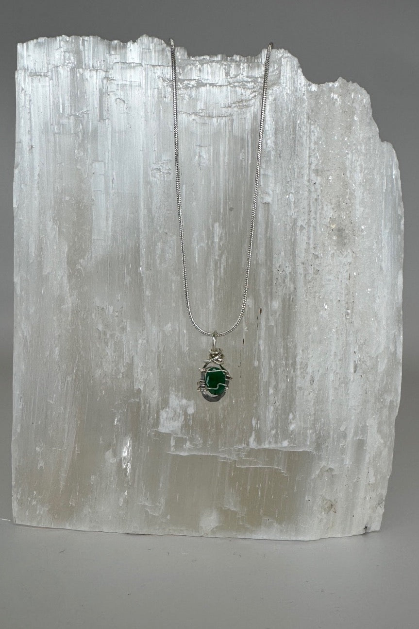 Raw Emerald Wire-Wrapped Pendant Necklace in Green & Silver — full necklace displayed on white selenite