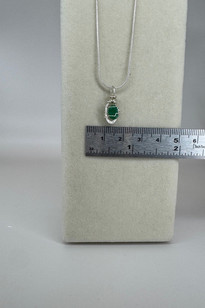 Raw Emerald Wire-Wrapped Pendant Necklace in Green &amp; Silver — close-up of pendant and wire wrapping beside ruler