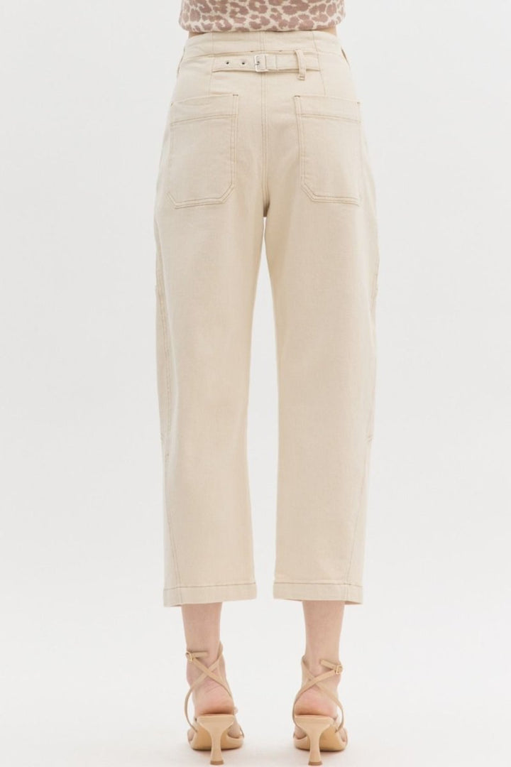 Woman wearing Entro ecru high-waist straight leg pants featuring back buckle at waist.