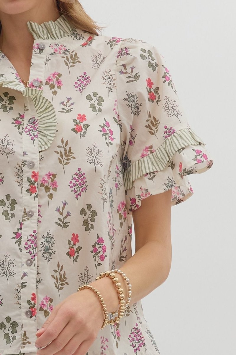 Floral patterned shirt worn by a person on a plain background