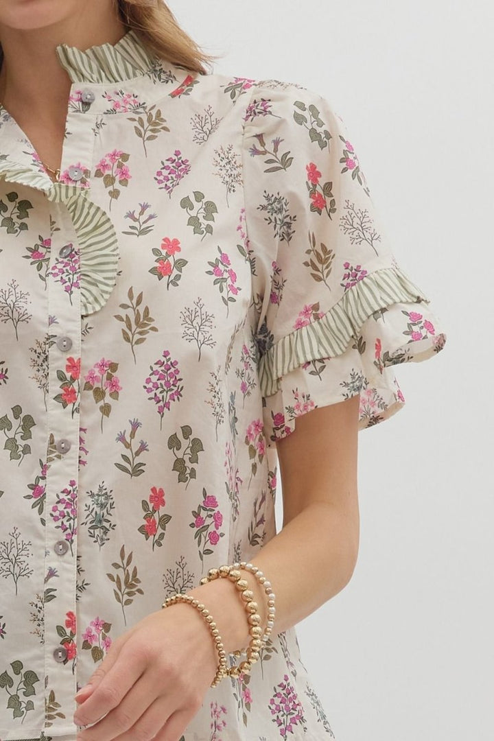 Floral patterned shirt worn by a person on a plain background