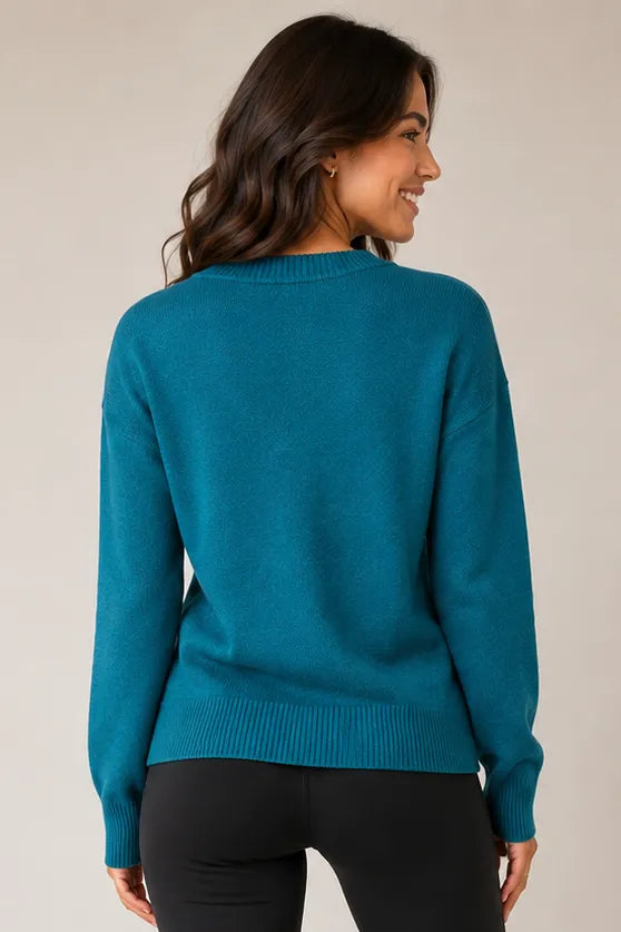 Jersey Stitch V-Neck Sweater in Spruce Green — back view showing straight hem and ribbed cuffs