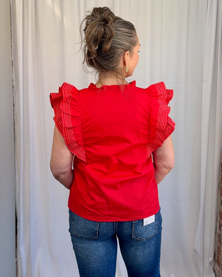 Carole Christian Game Day Flutter Sleeve Top in Red — back ruffle detail close-up, white contrast stitching, model wearing Small, Modish Maven Boutique