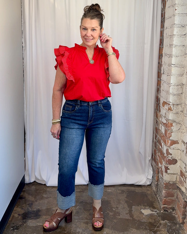Carole Christian Game Day Flutter Sleeve Top in Red — full front outfit view with dark wash jeans and brown platform sandals, model wearing Small, Modish Maven Boutique