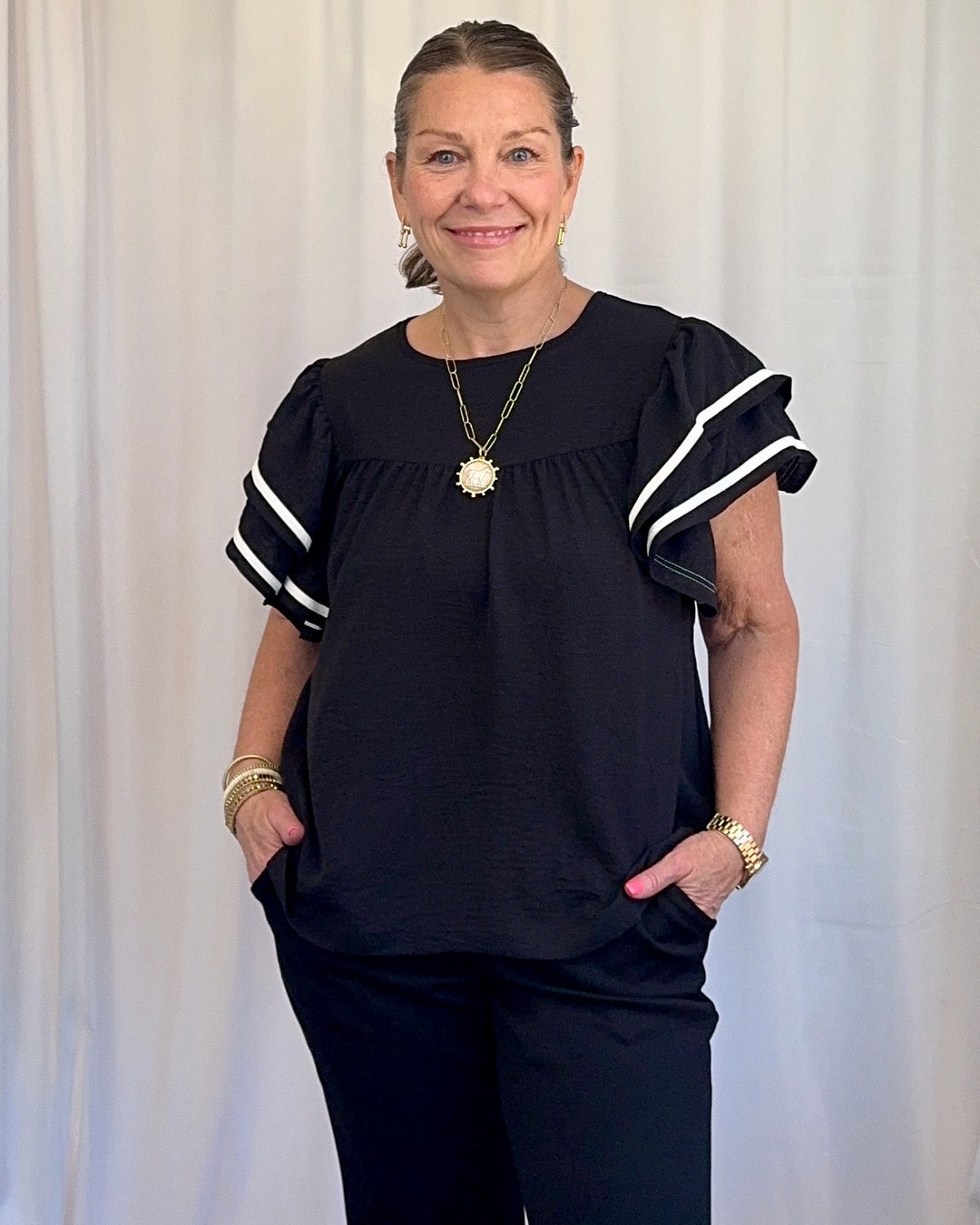 Carole Christian Game Day Ruffle Sleeve Textured Top in Black — round neckline and white contrast ruffle sleeve detail close-up, model wearing Small, Modish Maven Boutique