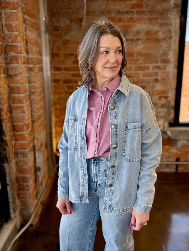Dear John Denim Gina Relaxed Fit Denim Jacket in Zurie wash styled with pink button-down shirt on model
