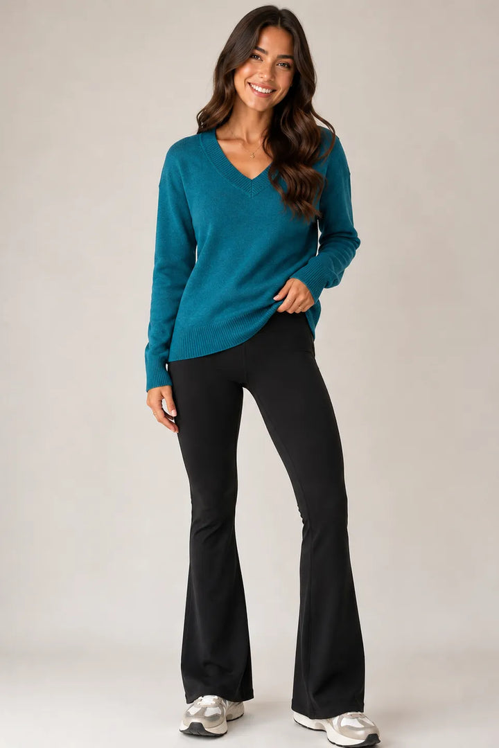 Jersey Stitch V-Neck Sweater in Spruce Green — full outfit view with black flared pants and sneakers
