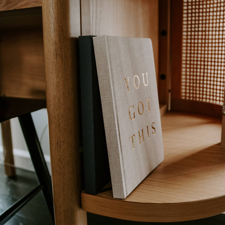 Journals on a wood shelf.