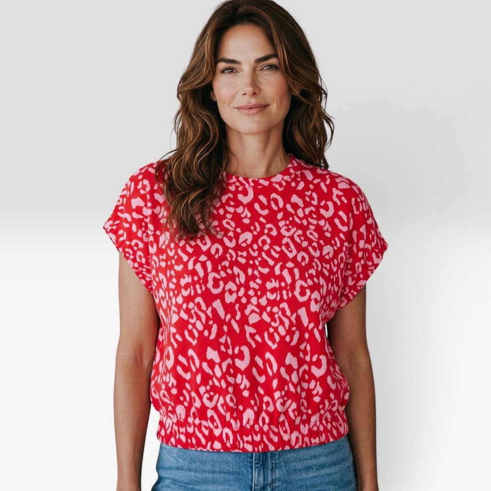 Leopard Print Smocked Waist Top in Red Pink close-up on model, crew neck and elastic cuff dolman sleeve detail.