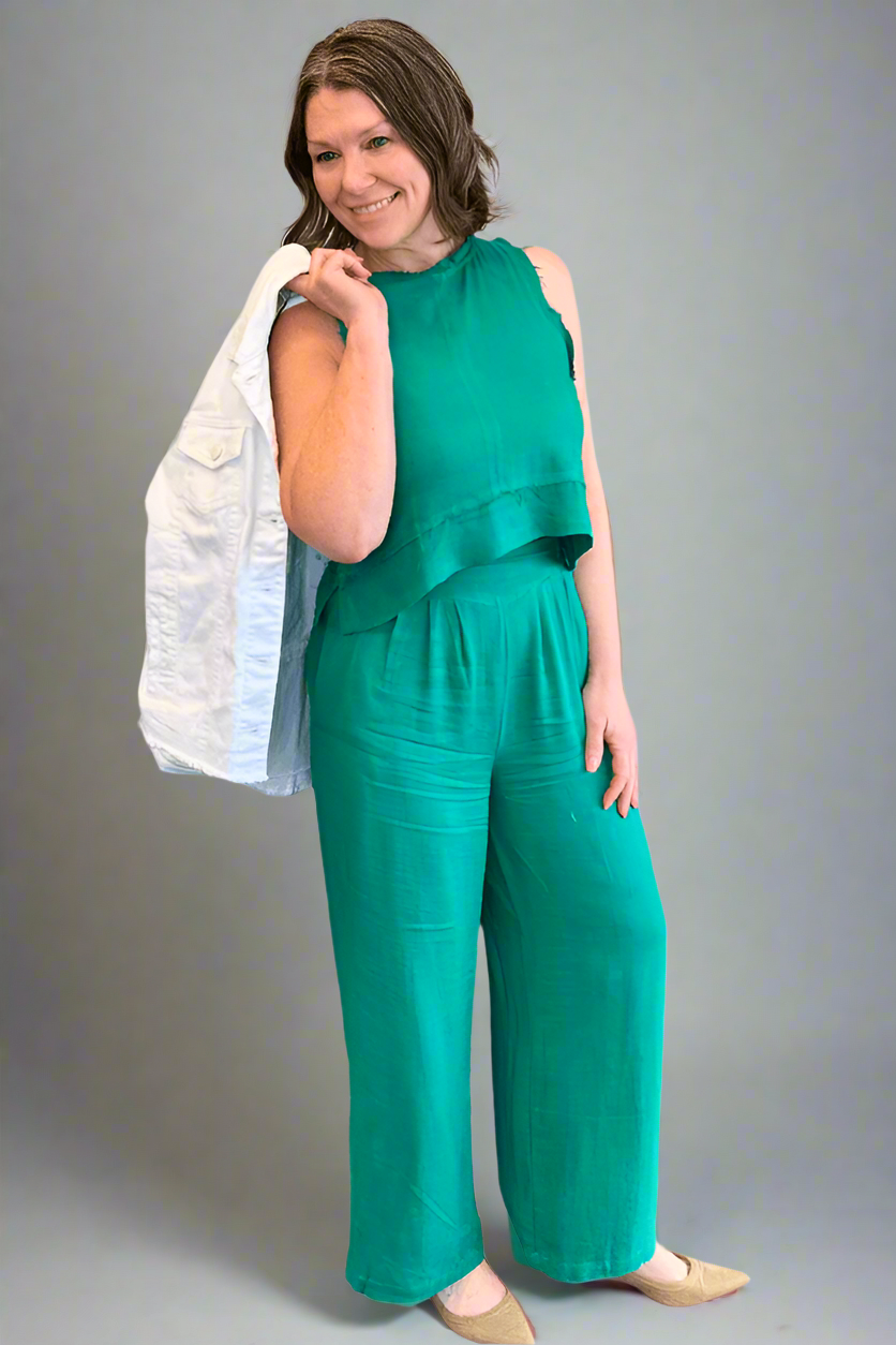 Woman wearing the Jade Green Linen Tank and Wide Leg Pant Set with jacket over shoullder.
