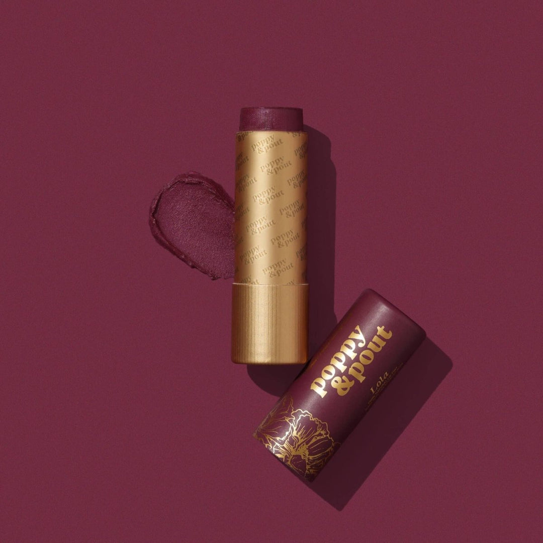 Poppy and Pout Lola Lip Tint in eco-friendly cardboard packaging, featuring a deep wine colored natural balm.