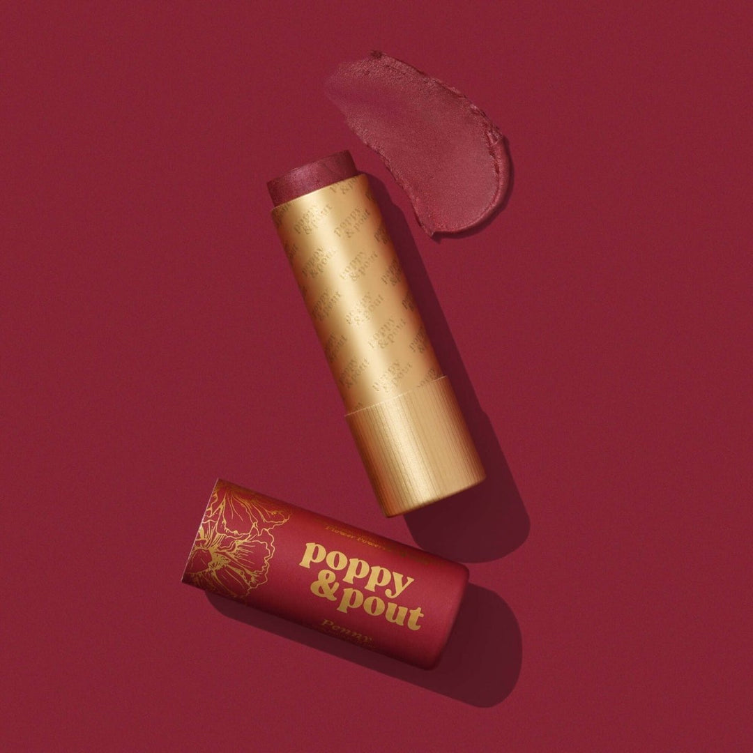 Poppy and Pout Penny Lip Tint in a sustainable cardboard tube, featuring the perfect shade of sheer red natural balm.