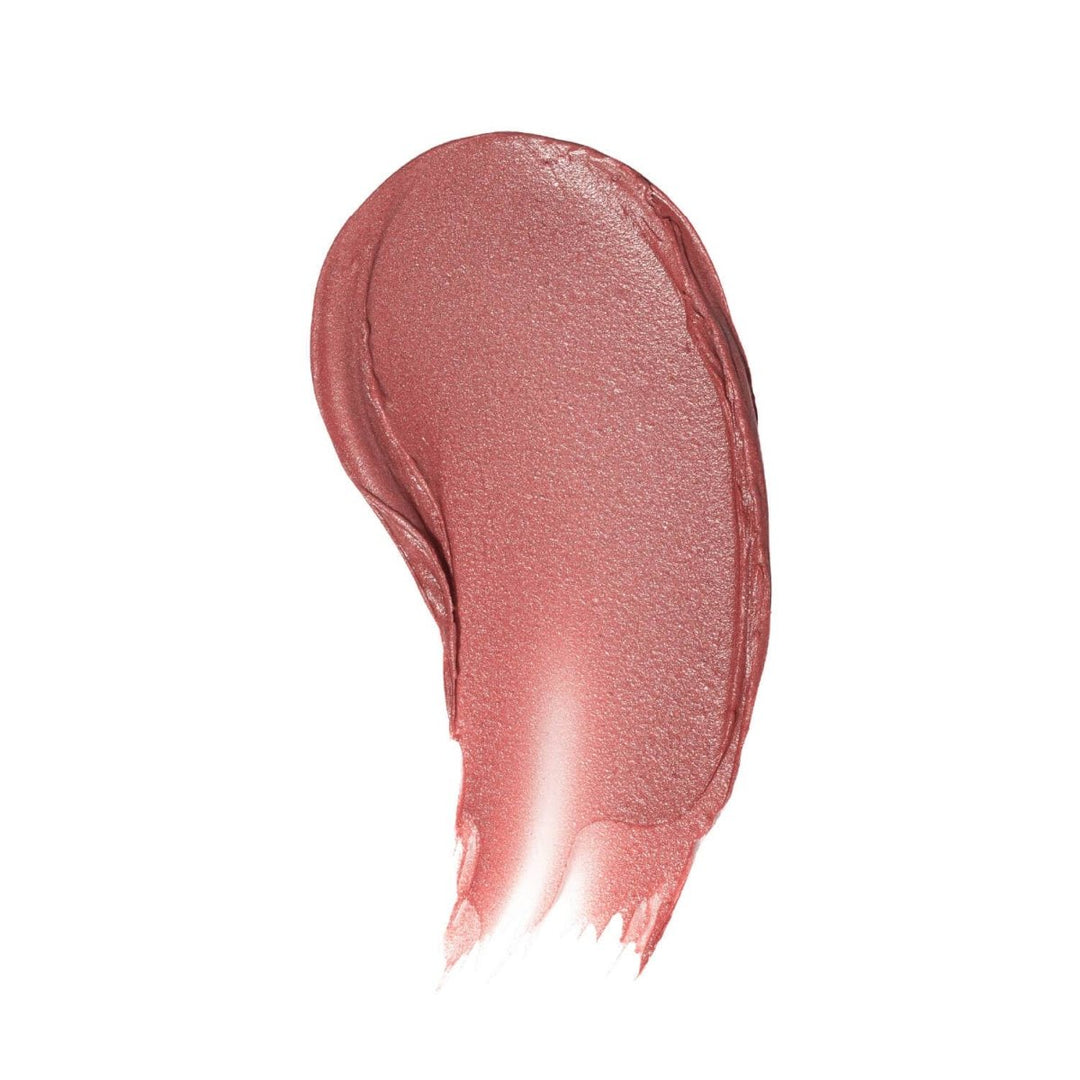 A smooth, buttery color swatch of Roxie Lip Tint on skin, displaying the rich brick red pigment and natural texture.