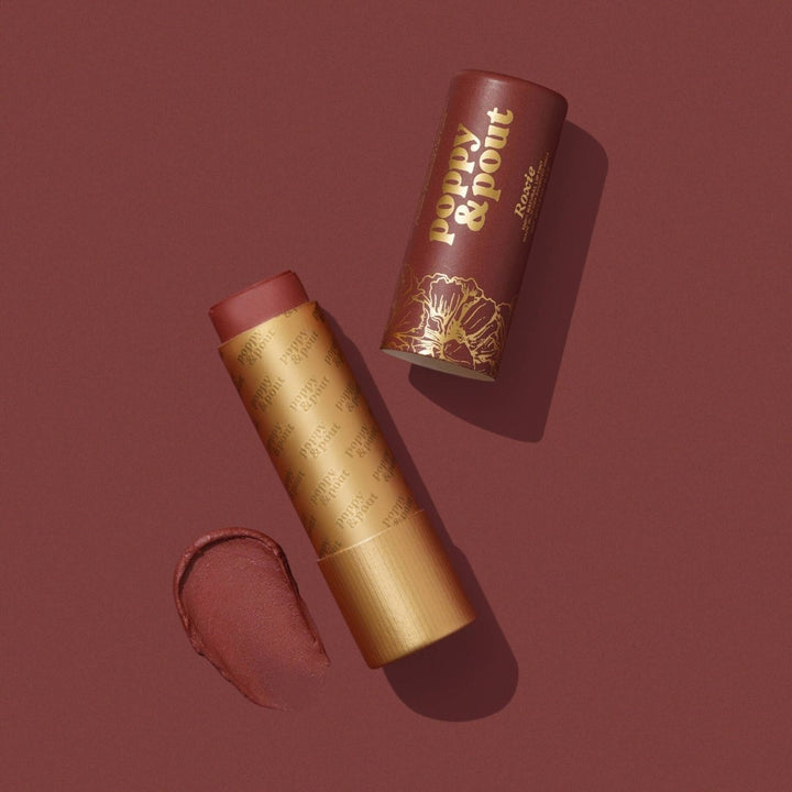 Poppy and Pout Roxie Lip Tint in eco-friendly cardboard packaging, featuring our best-selling brick red natural balm.