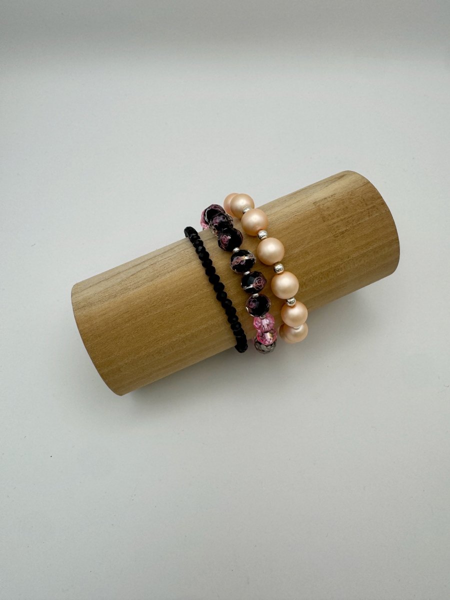 Lizzy Lu Diva Bracelet Set in Blush Noir — three beaded bracelets stacked on a wooden display