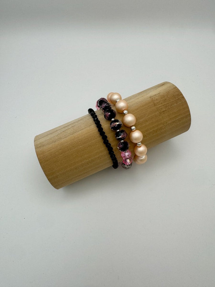 Lizzy Lu Diva Bracelet Set in Blush Noir — three beaded bracelets stacked on a wooden display