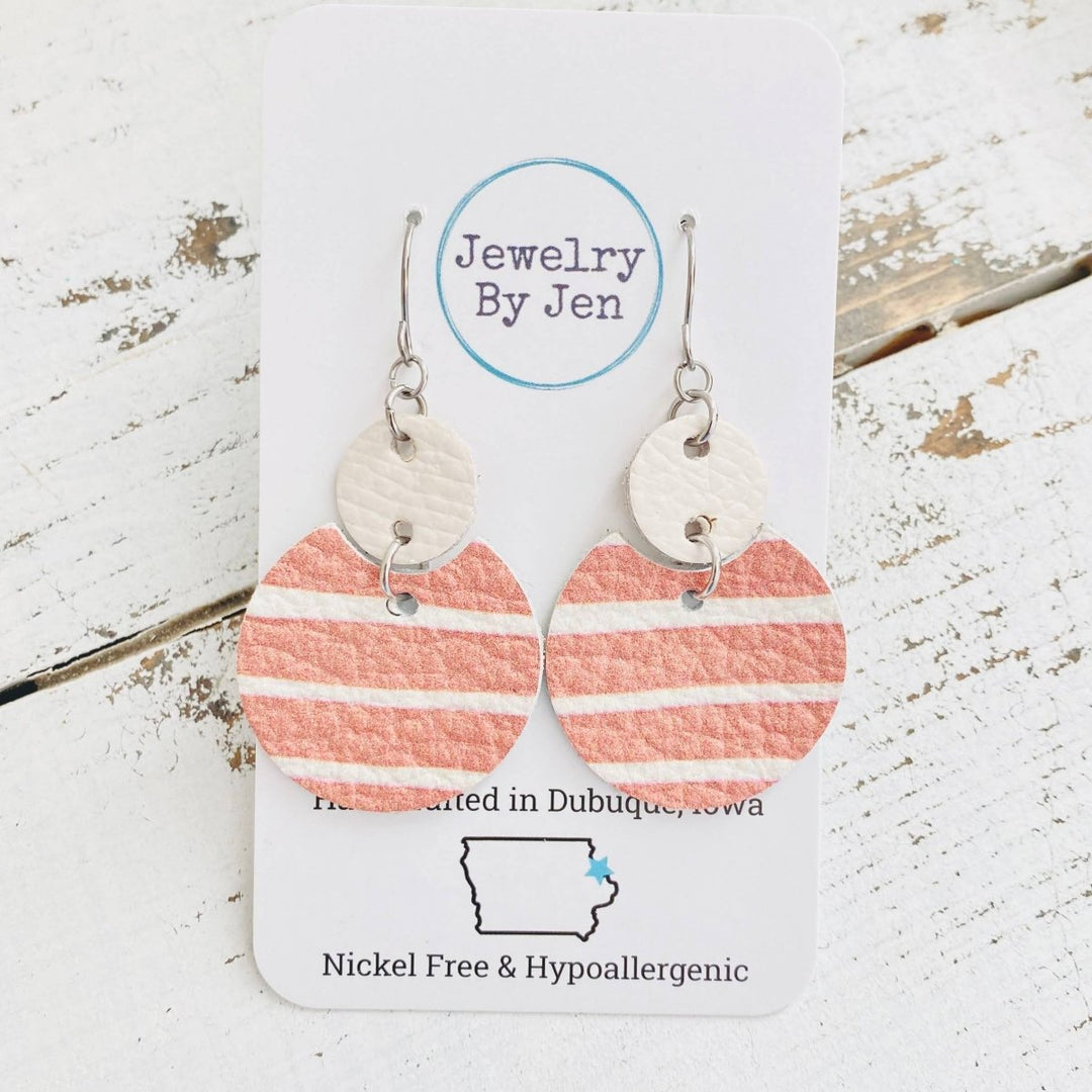 Heart-shaped earrings with pink and white stripes on a &