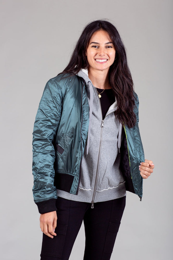 My Anorak Iridescent Hooded Down Bomber Jacket in Kryptonite — front view on model, unzipped showing built-in hoodie