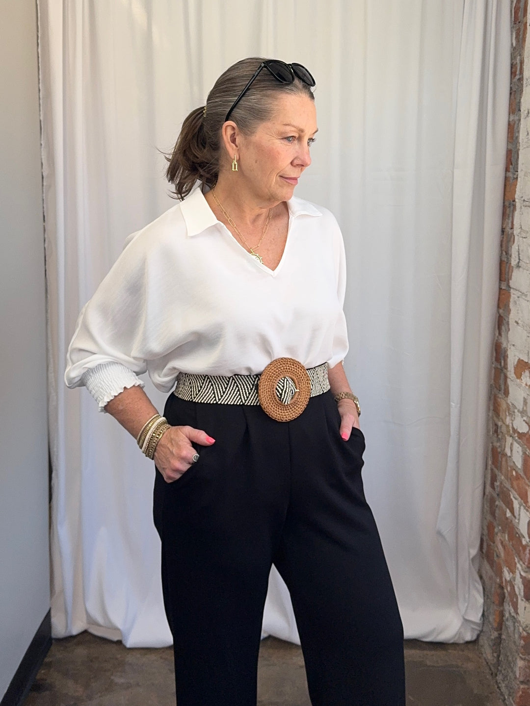 Carole Christian Relaxed Collar V-Neck Smocked Sleeve Blouse in White — front view on model, tucked and belted