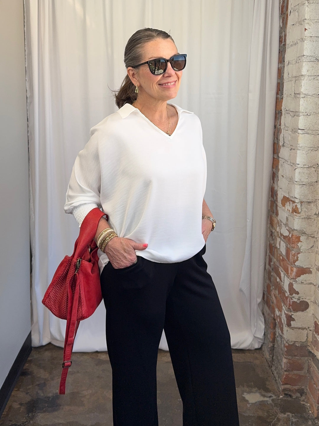 Carole Christian Relaxed Collar V-Neck Smocked Sleeve Blouse in White — close-up front view on model, untucked