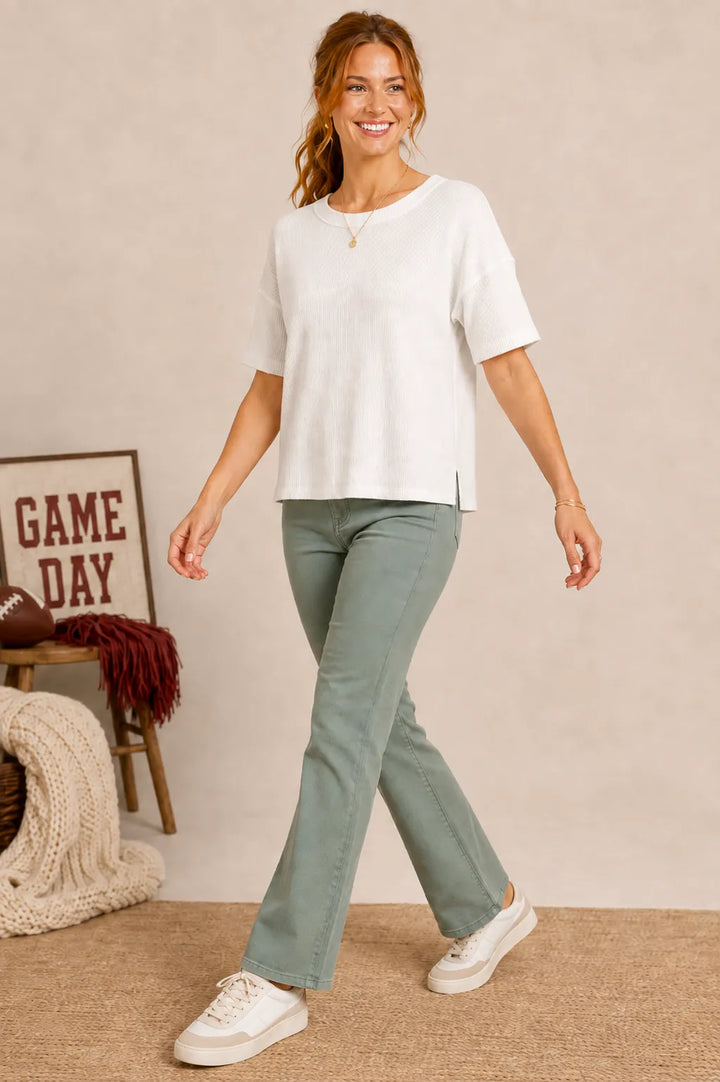 Ribbed Knit Raw-Trim Drop Shoulder Tee in White — outfit view with sage pants and white sneakers