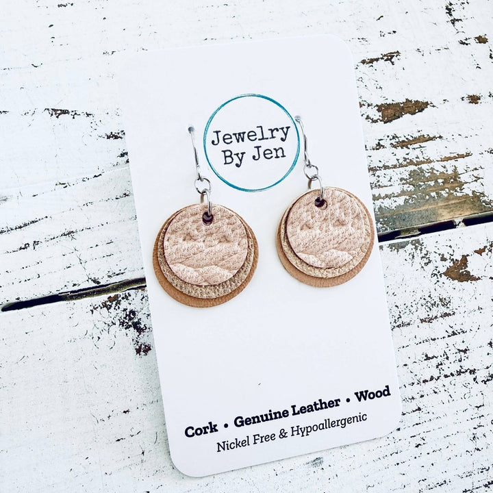 Pair of layered cork earrings on a &