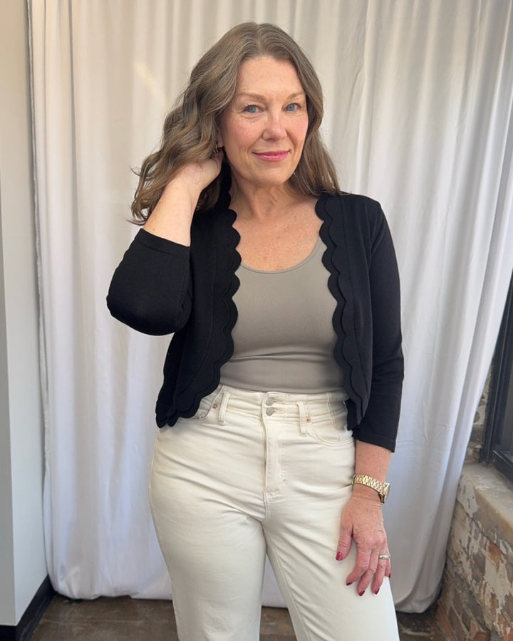 Zac &amp; Rachel Scallop Knit Shrug Cardigan in Black, 3/4 sleeve and scallop hem detail, close view on model
