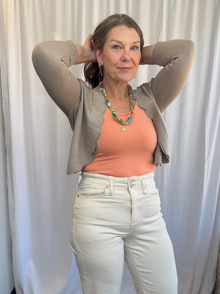 Scallop Knit Shrug Cardigan in Cobblestone styled with peach tank and cream wide-leg jeans, full outfit front view on model
