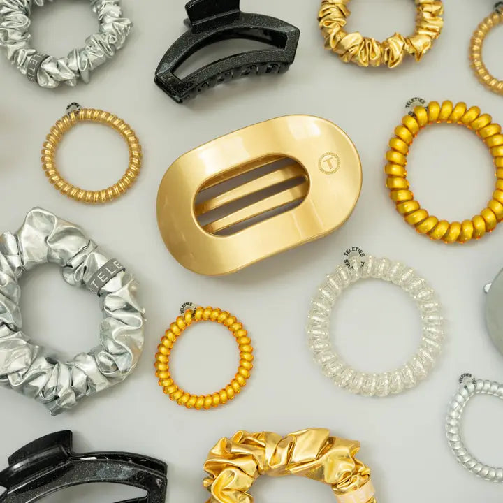 Collection of hair accessories including scrunchies and clips on a light background