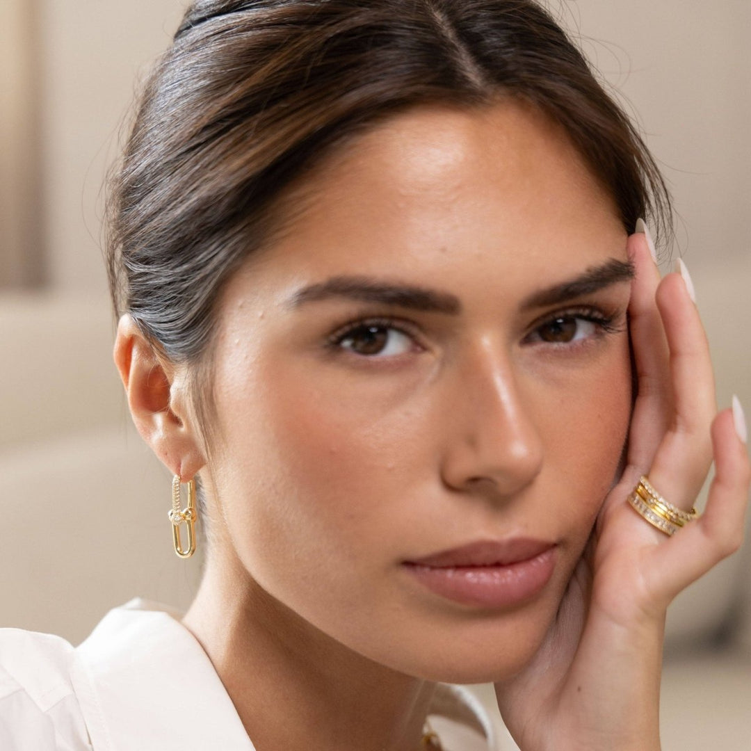 Tia U Link Pave Earring in Gold — close-up on model with hair tucked behind ear