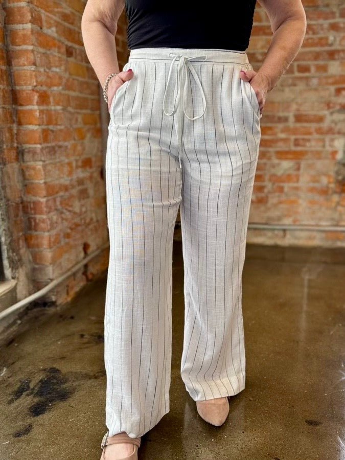 Wide Leg Striped Palazzos in with an elastic drawstring waist, front pockets and wide leg silhouette, front view on model