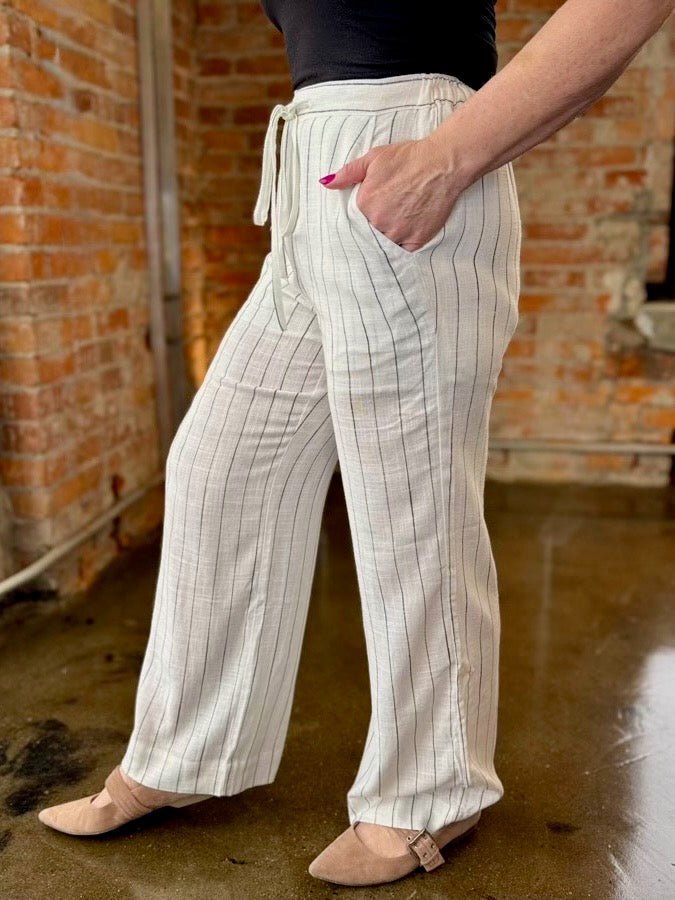 Dex Wide Leg Striped Palazzos, relaxed wide leg with front pocket and drawstring waistband detail, side view on model